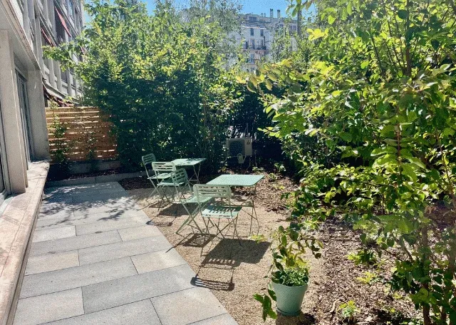 Photo de l'espace arbore avec une terrasse en metal verte anis du centre de physiotherapie Helvetic Physio geneve